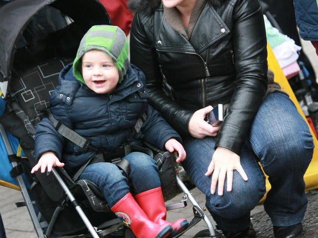 Young TJ McCabe and mum Denise pictured enjoying the floats during Sunday's St. Patrick's Day parade in Buncrana. 1903JM47