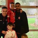 Derry City players Daniel Lafferty with his son and Jordan Mc Eneff with his nephew who both attend St. John’s Primary school.