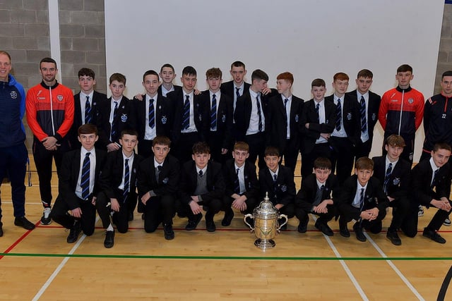 Derry City players Michael Duffy, Liam Mullan and Jordon McEneff pictured with St Columb's College Year10 pupils and PE teacher James Green during a visit to the school, with the FAI Cup, on Monday. Photo: George Sweeney. DER2247GS - 24