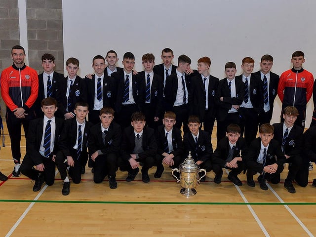Derry City players Michael Duffy, Liam Mullan and Jordon McEneff pictured with St Columb's College Year10 pupils and PE teacher James Green during a visit to the school, with the FAI Cup, on Monday. Photo: George Sweeney. DER2247GS - 24