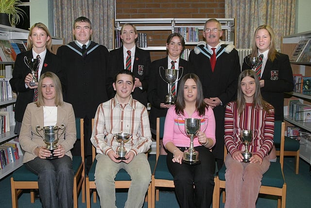 Pupils who collected awards at Clondrmot HIgh Schools annual Prize-Giving.  Seated (from left), Laura Hutchinson, cup for Fieldwork in Geography, Ross Shields, English cup, Kimberley Downey, cup for IT and Laura Hawthorne, Science cup.  Standing (from left), Stephanie Olphert, cup for General Excellence in Year 13, David Funston, vice-principal, Amy Rutherford, Young Enterprise cup in Year 13, Stacey-Lea Jackson, Hockey cup, Robert Logue, vice-principal, and Deborah Hawthorne, Georgraphy cup. (2810T08).:Derry and Donegal secondary school pupils in October 2003