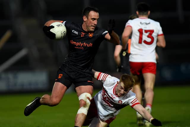 Derry's Declan Cassidy makes a brave tackle on Armagh's Niall Rowland during Saturday's McKenna Cup tie. (Photo: John Merry)