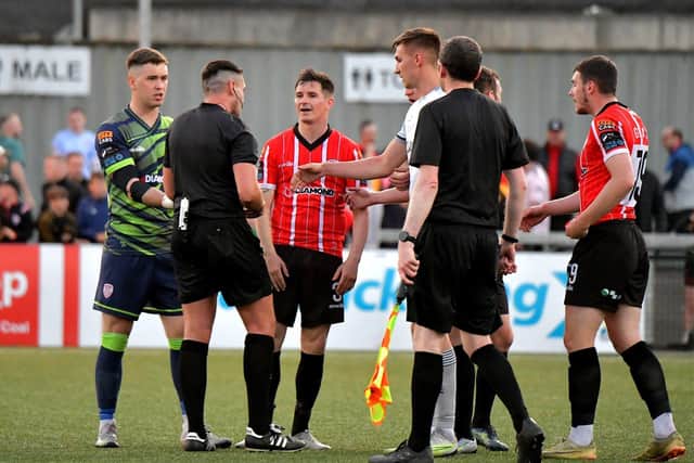 Derry City players approach referee Rob Hennessy after the final whistle. DER2321GS -