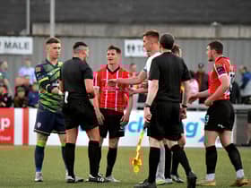 Derry City players approach referee Rob Hennessy after the final whistle. DER2321GS - 