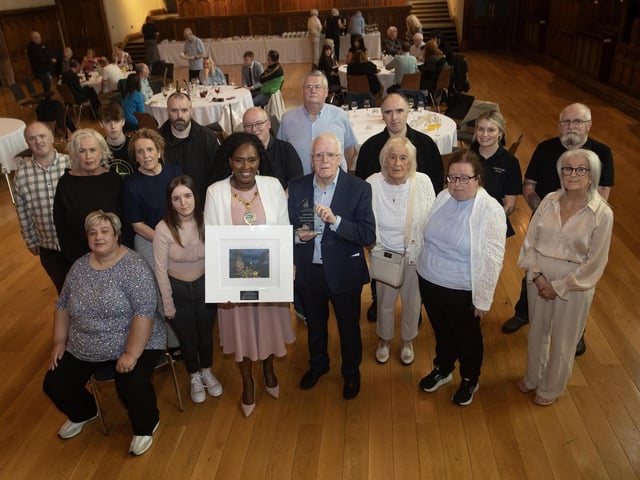 The Mayor, Lillian Seenoi-Barr makes a special presentation to John Kelly on the occasion a reception in the Guildhall on Monday evening to mark his retirement from the Bloody Sunday Trust. Included are John's family.