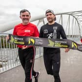 Waterside Half Marathon reigning senior men’s champion Kyle Doherty from City of Derry Spartans promoting the event on the Pennyburn Footbridge with Star Running Club members Patrick McCarry and Louise Wilkinson.