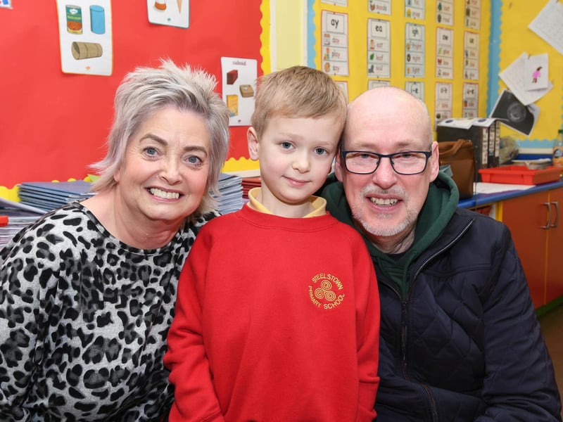 Primary 3 pupil James picctured with granny and grandad at Steelstown PS.
