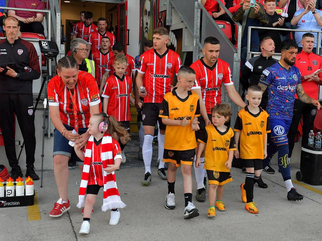 Mascots and Derry City players make their way onto the pitch on Friday evening. Photo: George Sweeney. DER2322GS – 152