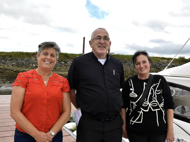 Sisters Caroline Walker and Elaine Craig pictured with Fr Paddy Baker at the Blessing of the Boats, Fahan Marina, on Sunday afternoon. Photo: George Sweeney