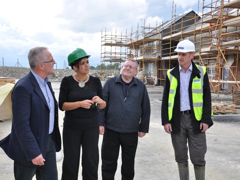 Sinn Féin representatives Raymond McCartney, Elisha McLaughlin, and Tony Hassan being shown around the new social housing development by a representative from Briadwater Developments. (2109MM09)