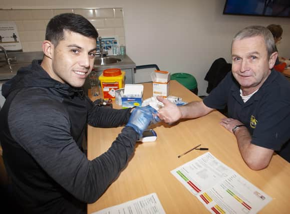 Local Creggan man Seamus Breslin gets a cholesterol check with the OLT’s Jonathan Peberdy during Saturday’s Men’s Health Checks at the Old Library Trust, Creggan. The event was part of the Communitities In Transition Programme. (Photos: Jim McCafferty Photography)