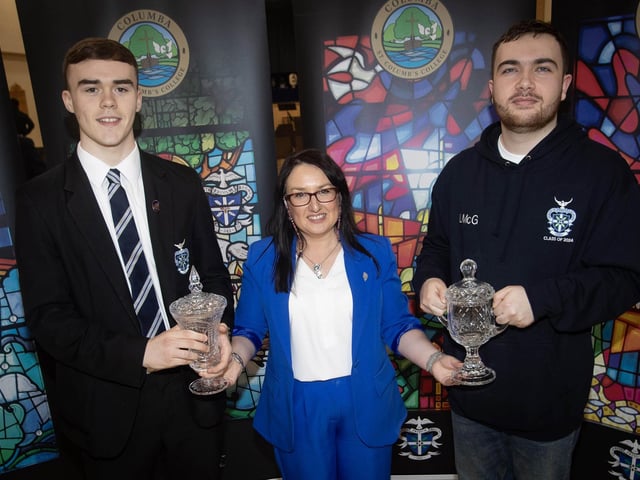 Mrs. Caroline McLaughlin, Principal, St. Columb's College presenting the Niall O'Kane Memorial Prize for Social Concern to Emmett McBrearty and the McCann Family Prize to Luc McGlinchey at Thursday's prizegiving.