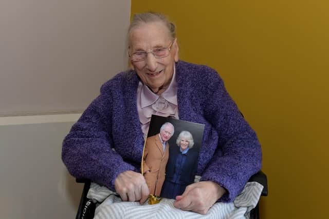 Centenarian Edith Gallagher pictured with a birthday card from King Charles III and Queen Camilla, at a celebration party held in Longfield Care Home, Eglinton. Photo: George Sweeney
