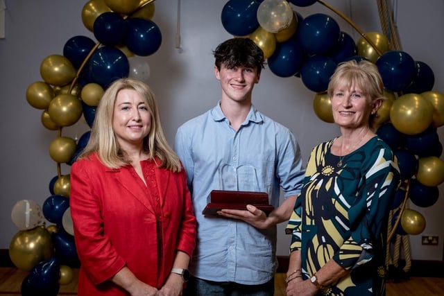Ronan Hegarty pictured with Mrs Jacinta Bradley (Board of Governors) & Mrs Maeve McMenamin (Head of English) receiving the Paul Wilkins Award for Top Student in A2 English Literature.