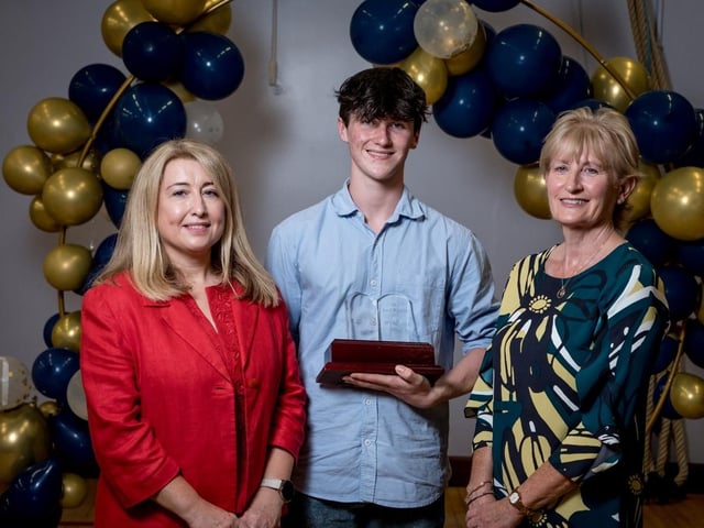Ronan Hegarty pictured with Mrs Jacinta Bradley (Board of Governors) & Mrs Maeve McMenamin (Head of English) receiving the Paul Wilkins Award for Top Student in A2 English Literature.