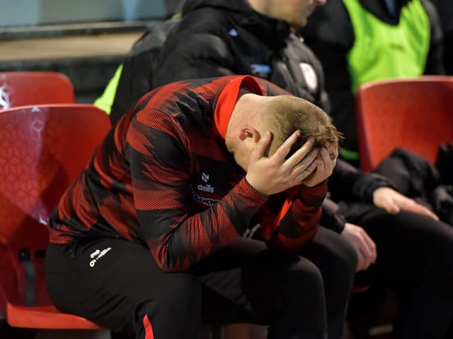 Derry City first team coach Andy Mitchell with his head in his hands.