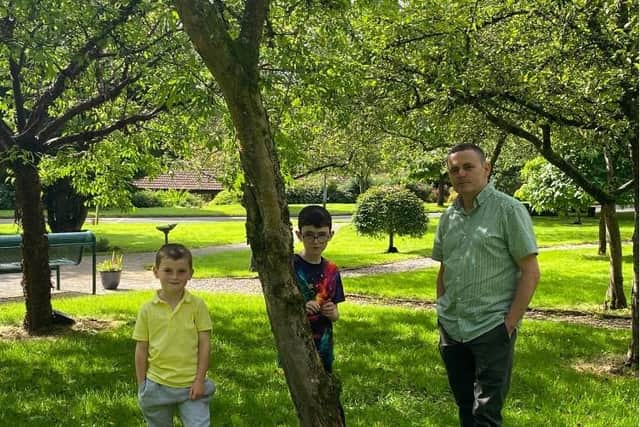 Anthony Fitzgerald, pictured with his two sons, whose wife died from cancer at Foyle Hospice in 2021.