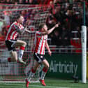 Ronan Boyce and Carl Winchester celebrate Derry City's equaliser against Cork City in front of the North Stand.