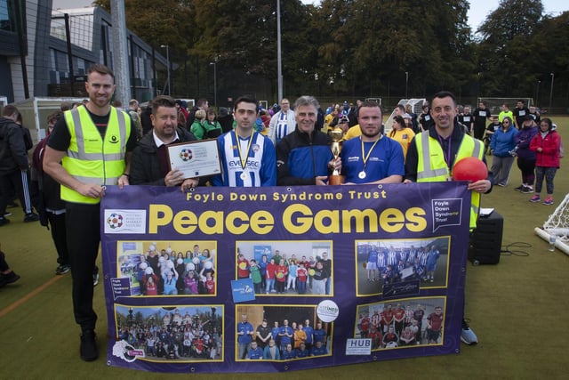Former Northern Ireland International and ex-Derry City manager Felix Healy presents Connor Harkin, Destined FC with the Peace Games trophy. Included from left is Christopher Cooper, FDST, Ernie Brennan, FMOSH chief executive officer, captain Coleraine Strikers and Connor McGilloway, FDST.