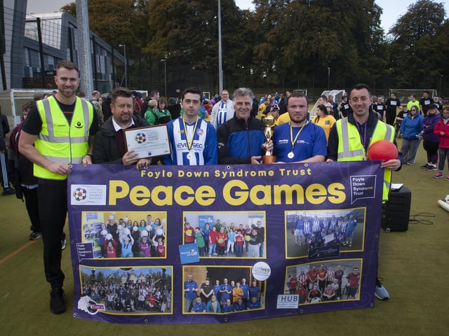 Former Northern Ireland International and ex-Derry City manager Felix Healy presents Connor Harkin, Destined FC with the Peace Games trophy. Included from left is Christopher Cooper, FDST, Ernie Brennan, FMOSH chief executive officer, captain Coleraine Strikers and Connor McGilloway, FDST.