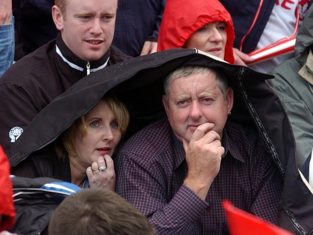 Taking shelter at Croke park as the large Derry contingent endured intermittent showers . (3108A22)