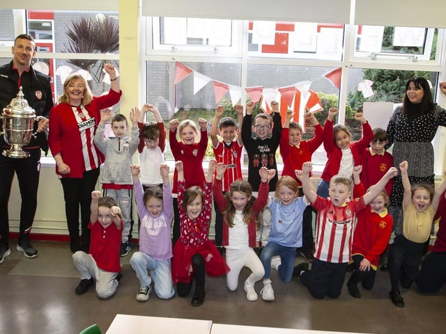 Steelstown Primary School's Mr. Mulhern and his P4 class welcome Shane and Patrick McEleney with the FAI Cup. (Photo: Jim McCafferty)