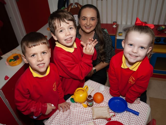 Miss Eimear Lavery pictured with some of her P1 class at Steelstown PS this week. :.