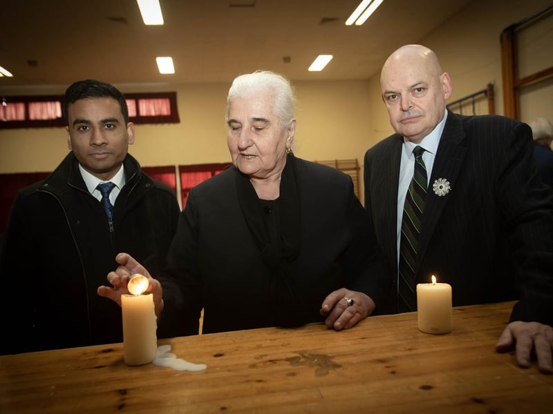 Mrs. Munira Subašić, president of the Mothers of Srebrenica and Zepa Enclaves, lights a candle at Oakgrove Intgrated College last week. Included are Amil Khan, Remembering Srebrenica and Peter Osborne, chair, Remembering Srebrenica NI. (Photos: Jim McCafferty Photography)