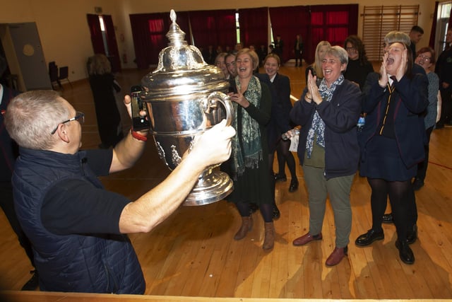 Oakgrove Integrated College staff getting photos taken with the FAI Cup.