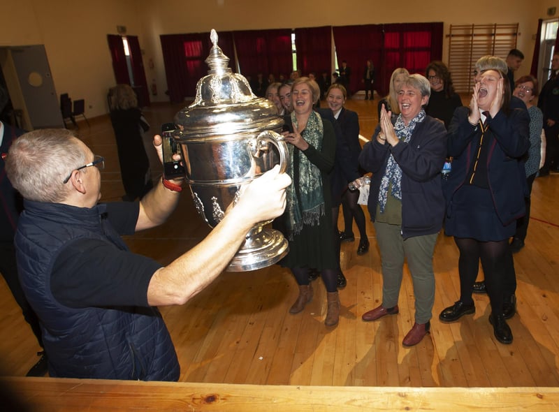 Oakgrove Integrated College staff getting photos taken with the FAI Cup.
