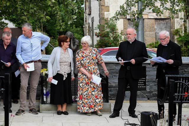 The Rev. David Slater, Church of Ireland, and Fr. David O’Kane, PP, VF, with relatives of those killed and injured in the Claudy car bombing on 31 July 1972 at the unveiling of the newly-refurbished memorial on Wednesday evening. Photo: George Sweeney