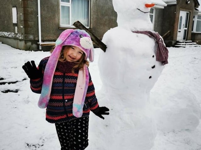 Evie with 'Frosty' the snowman in Drumfries.