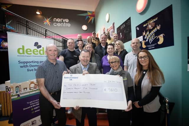 £5,610 DEEDS CHEQUE!. . . .Sinead Devine, Co-Ordinator, DEEDS, Old Library Trust, accepting a cheque for £5,610 from Willie Barrett, proceeds of monies collected during the Gweedore Reunion 2024 event. In centre is Peter Cunnah from D:Ream. Included are George McGowan, Project Director, Old Library Trust, OLT staff, event organisers and musicians. (Photo: Jim McCafferty Photography)