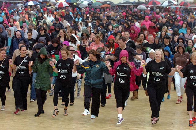 Thousands brave the heavy rain during the six minute Riverdance routine on Sunday. (DER3313PG129)