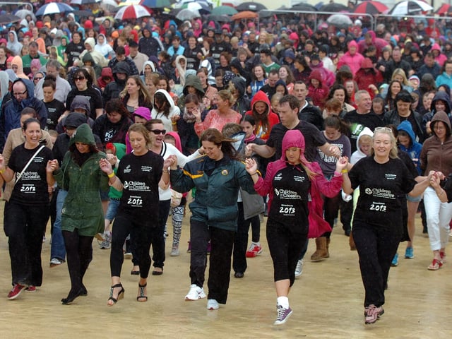 Thousands brave the heavy rain during the six minute Riverdance routine on Sunday. (DER3313PG129)
