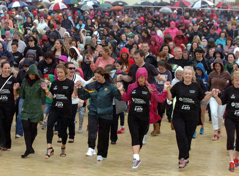 Thousands brave the heavy rain during the six minute Riverdance routine on Sunday. (DER3313PG129)