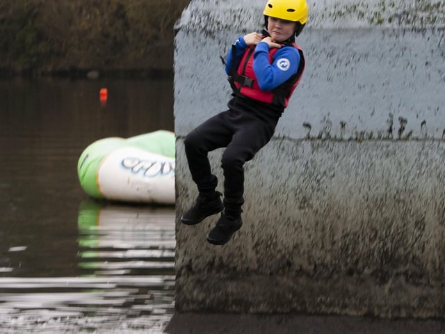COOL DUDE!. . . .One of the young St. Joseph’s pier jumpers makes his descencion into the cold waters of the reservoir on Saturday.