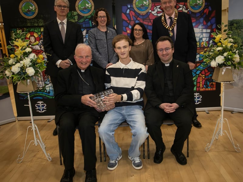Bishop Donal McKeown presenting the John McDaid Memorial Prize to Aaron O'Doherty (Head Boy Emeritus) during Thursday's prizegiving. On right at front is Fr Stephen Ward (School Chaplain). At back from left are Mr Brendan McGurk KC (Guest Speaker and Past Pupil), Mrs Ursula Grimley (VP), Mrs Caroline McLaughlin (Principal), and Mr Paul Brennan (Chair of the Past Pupil Union). : .