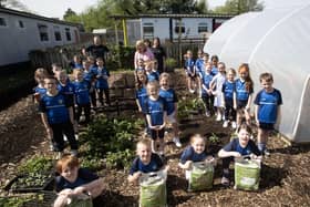 COMPOSTING. . . . Pupils from Hollybush Primary School pictured celebrating 'International Compose Awareness Week' at the school on Tuesday of this week. Included are Kyle Suckling and Sharon McMaster, Natural World Products. (Photos: Jim McCafferty Photography)