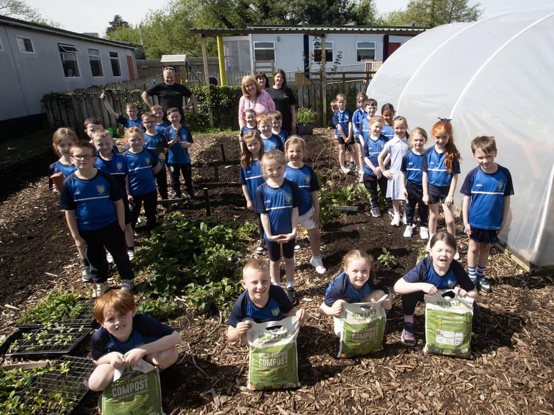 COMPOSTING. . . . Pupils from Hollybush Primary School pictured celebrating 'International Compose Awareness Week' at the school on Tuesday of this week. Included are Kyle Suckling and Sharon McMaster, Natural World Products. (Photos: Jim McCafferty Photography)