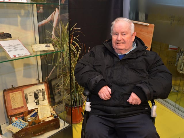 Former volunteer member of the Derry Corps of the Order of Malta Hugh Deehan, who was in the Bogside on Bloody Sunday. pictured pictured beside exhitits, including a photograph of himself at the Order of Malta Exhibition launch in the Museum of Free Derry on Monday evening last. Photo: George Sweeney. DER2305GS – 49