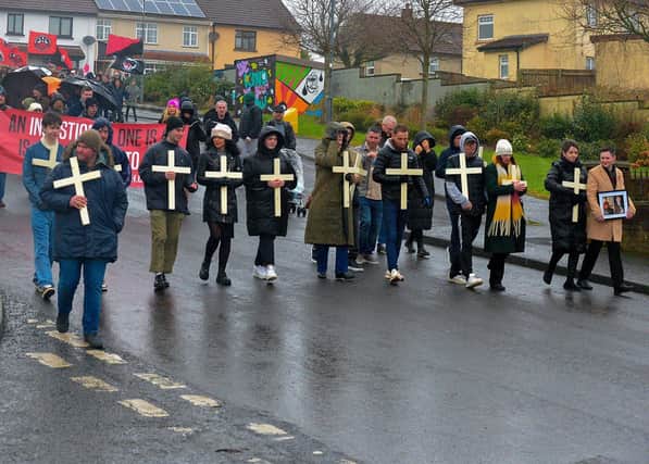 Relatives carrying white crosses lead the Bloody Sunday 51 commemoration march along Rathlin Drive on Sunday afternoon. Photo: George Sweeney. DER2306GS – 23