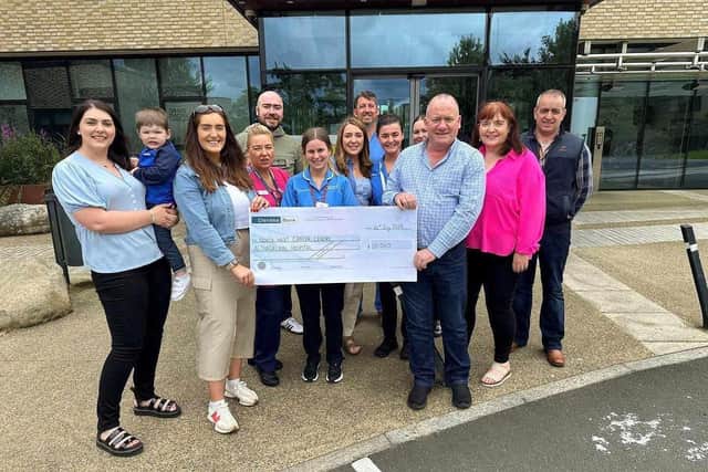The Ward family and friends present a cheque to the North West Cancer Centre.