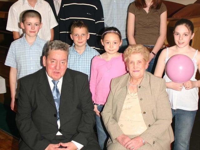 Mary and Jim McClenaghan pictured with their Grandchildren at the Surprise 50th Wedding Anniversary Party. 5088dd : McClenagan.