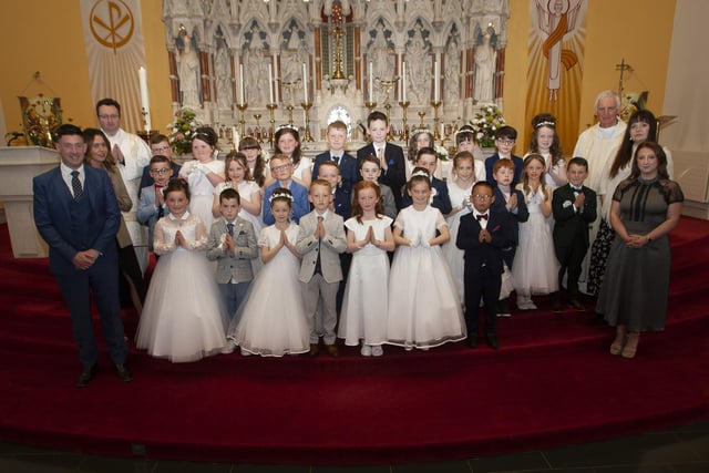 Pupils from Good Shepherd Primary School who received the Sacrament of First Holy Communion from Fr. Michael Canny at St. Columba’s Church, Waterside on Saturday last. Included in photo are Mr B. Doherty and Miss J. Gillespie, teachers; Deacon Ward, Miss K. Krawczyk and Miss C. Donaghy, Learning support assistants. (Photos: Jim McCafferty Photography)