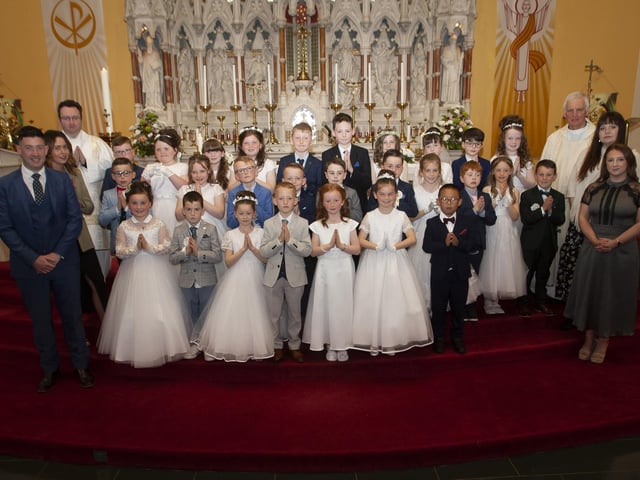 Pupils from Good Shepherd Primary School who received the Sacrament of First Holy Communion from Fr. Michael Canny at St. Columba’s Church, Waterside on Saturday last. Included in photo are Mr B. Doherty and Miss J. Gillespie, teachers; Deacon Ward, Miss K. Krawczyk and Miss C. Donaghy, Learning support assistants. (Photos: Jim McCafferty Photography)