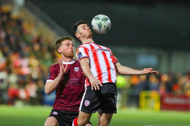 Derry City striker Danny Mullen controls the ball under pressure from a Galway defender.