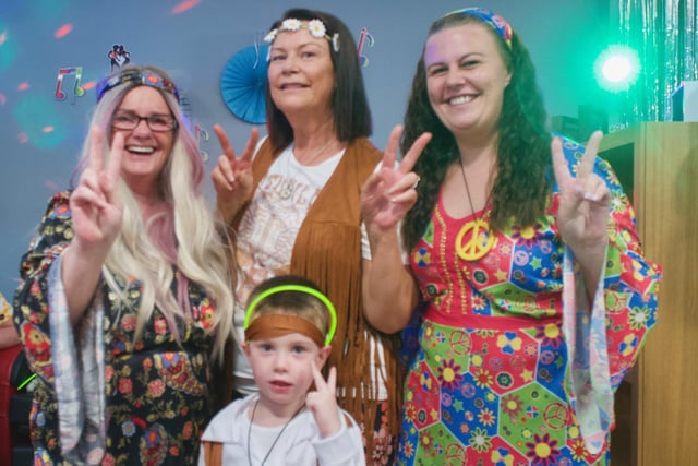 Domestic Bridget McCarron with her grandson, carer Georgina McCallion and carer Kelly McCallion at the 1960s and 1970s themed party at the Oakleaves Care Centre.