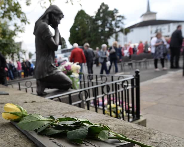 A previous service to mark the Claudy bombings at the memorial garden at the Market Square car park. Photo Colm Lenaghan/Pacemaker Press