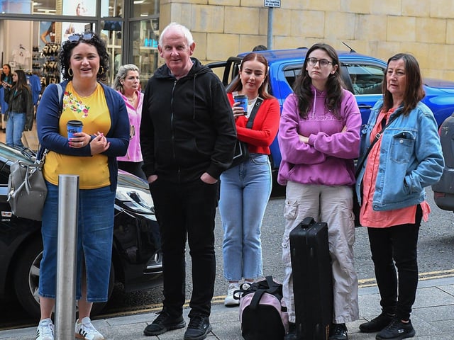 Spectators watch the Jaydee Brass Band performance outside the Millennium Forum on Friday evening. Photo: George Sweeney